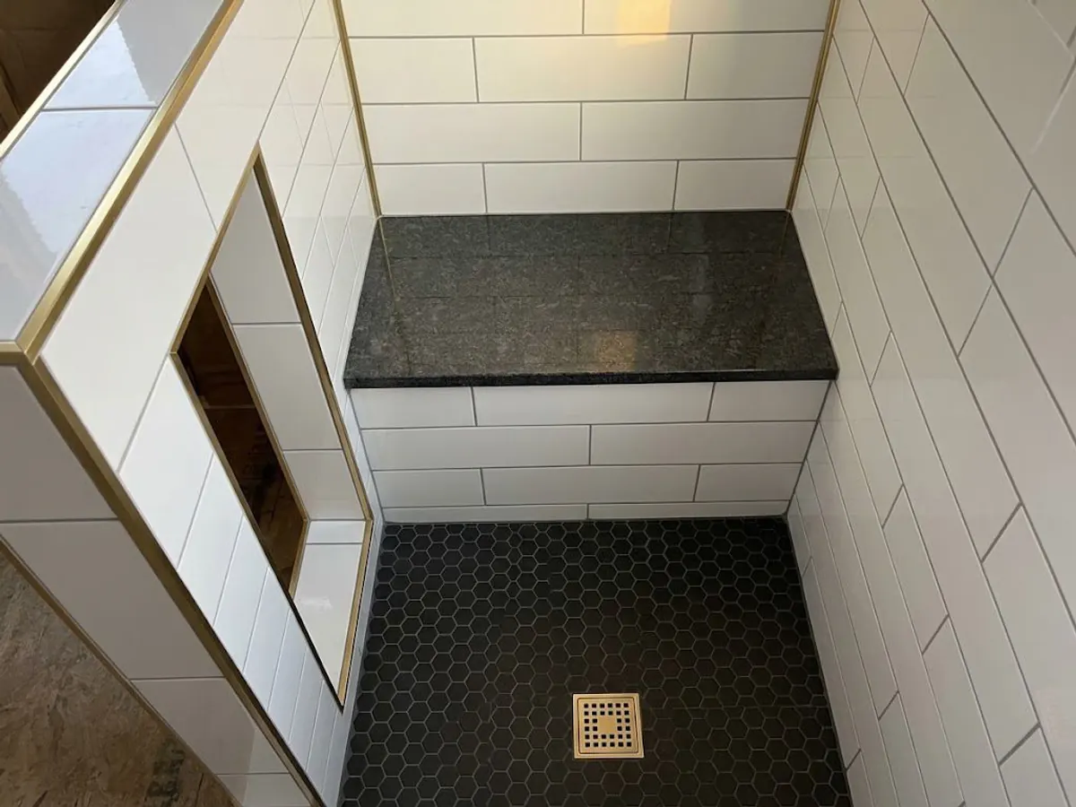 After: Before and after comparison: Custom tile shower with bench