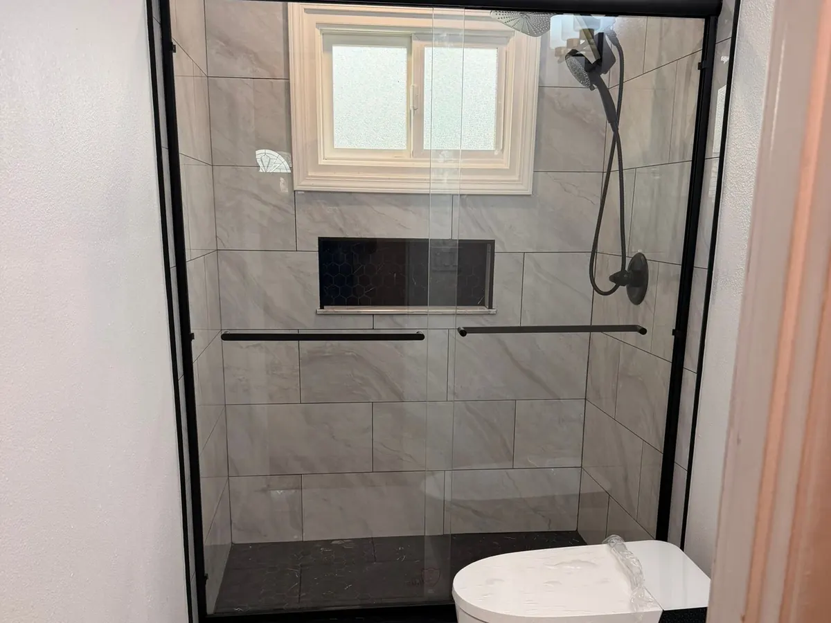 After: Before and after comparison: Shower rebuilt from the studs