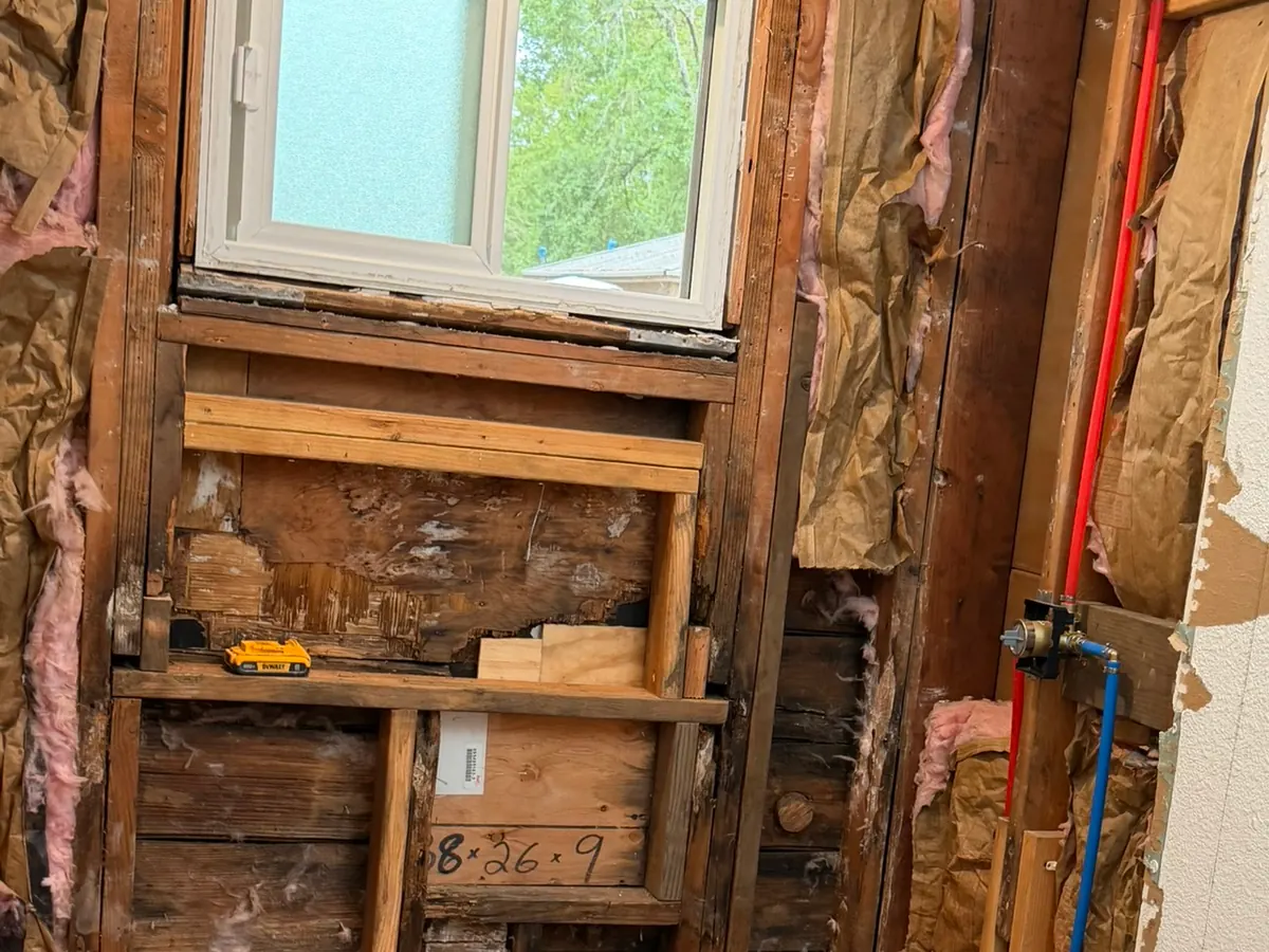 Before: Before and after comparison: Shower rebuilt from the studs